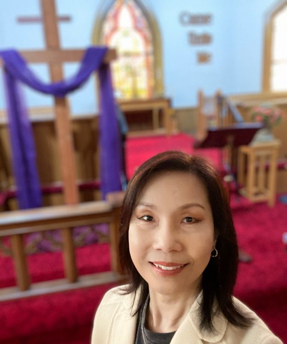Pastor Hannah in front of the Sanctuary
